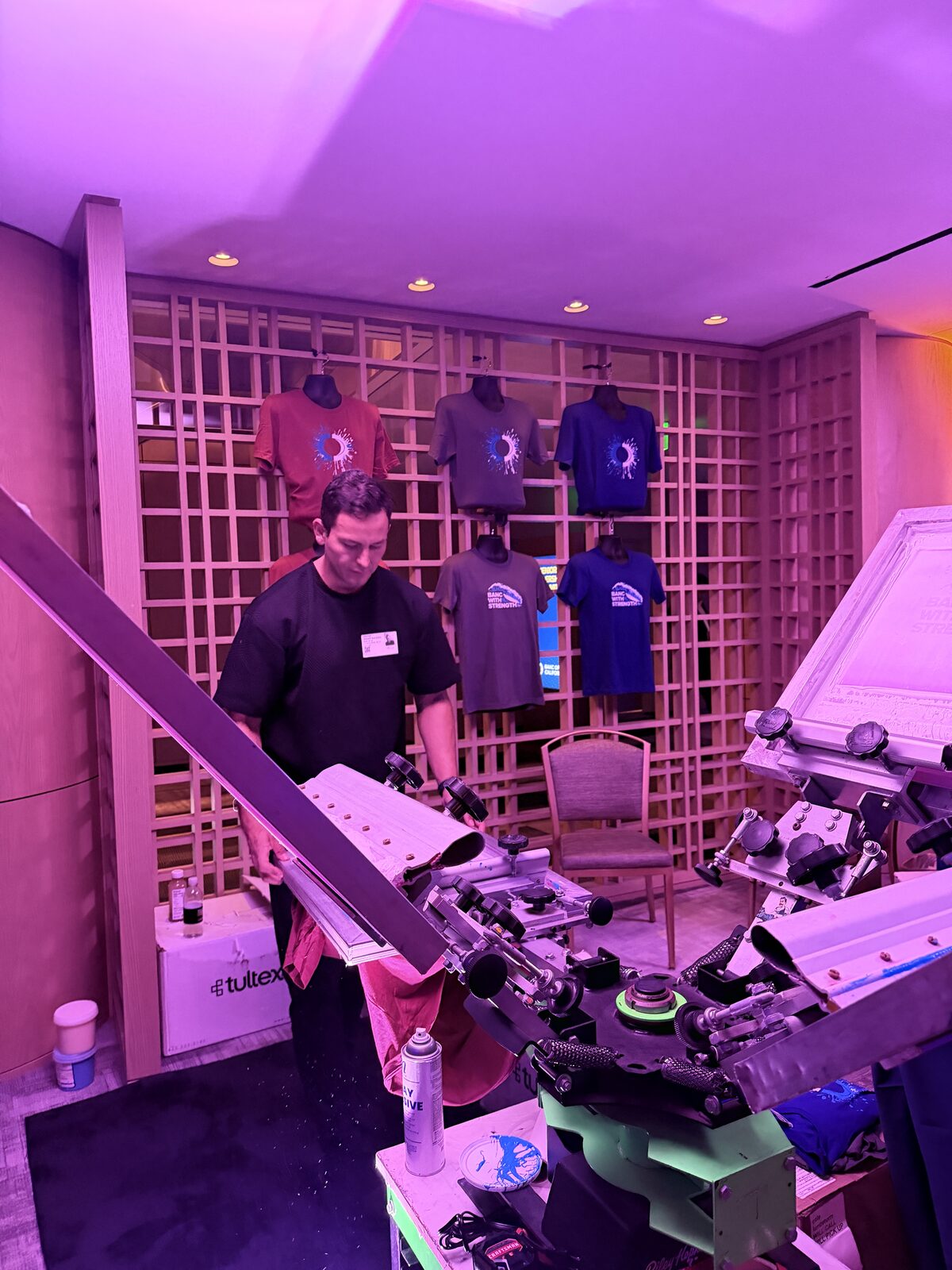 Operator loading a shirt onto a press