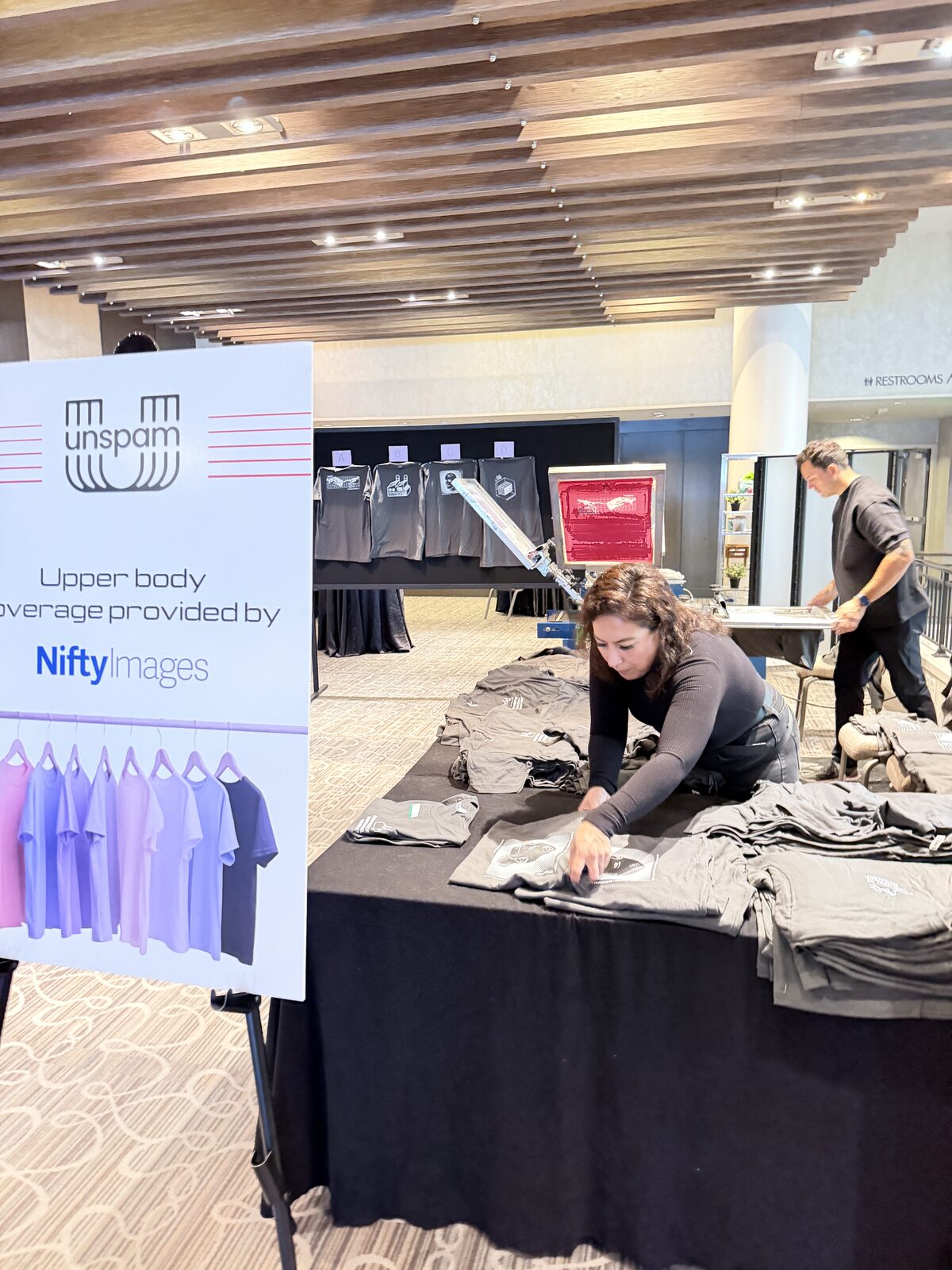 Conference merch table with printed shirts ready for guests