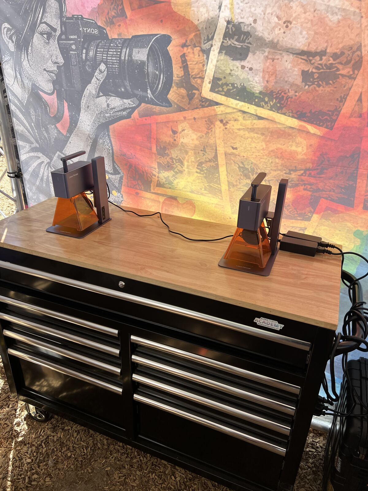 Laser engraving machine setup with finished products displayed on wood